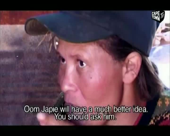 A person wearing a cap is speaking, their face lit by the camera. The Cape Town TV logo is in the corner, and subtitles pop up on the screen.
A person wearing a cap is speaking, their face lit by the camera. The Cape Town TV logo is in the corner, and subtitles pop up on the screen.