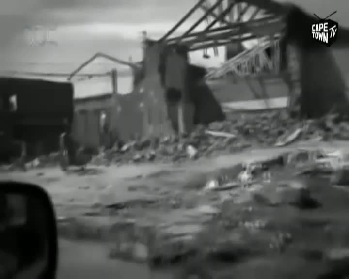 A building is in ruins, its roof caved in and debris scattered everywhere. A truck sits nearby, its side obscured by the damage. A building is in ruins, its roof caved in and debris scattered everywhere. A truck sits nearby, its side obscured by the damage.