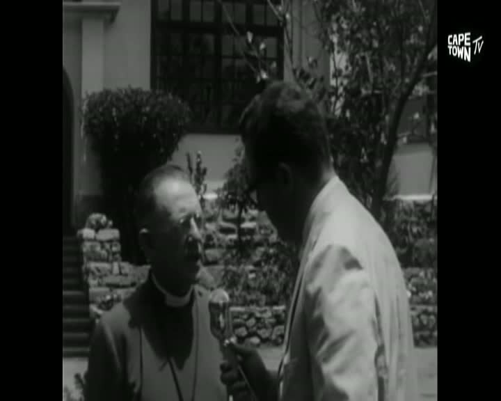 A man in clerical attire speaks into a microphone held by another man in a light suit. The Cape Town TV logo appears in the upper right corner. A man in clerical attire speaks into a microphone held by another man in a light suit. The Cape Town TV logo appears in the upper right corner.