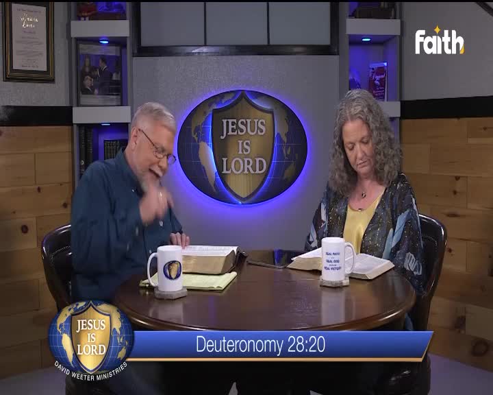 A man in a blue shirt gestures as he speaks, while a woman beside him reads from a Bible. The Faith TV logo sits in the corner, and a lower caption reads "Deuteronomy 28:20."
