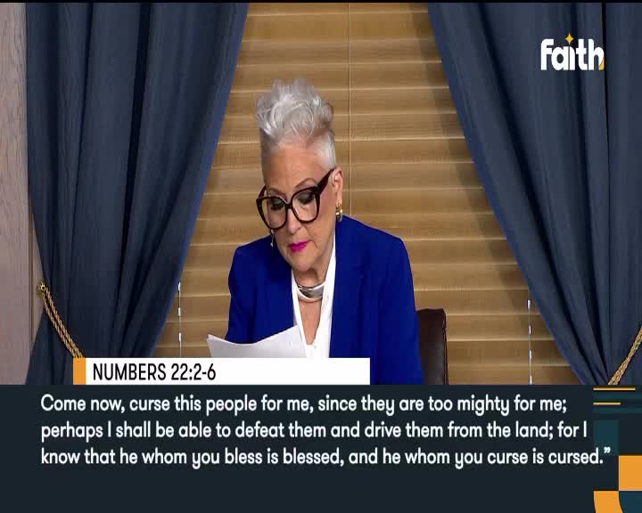 A woman in a blue blazer, wearing large glasses, reads from a paper, her focus fixed on the text. The Faith TV logo is visible, and a Bible verse is displayed below her.
