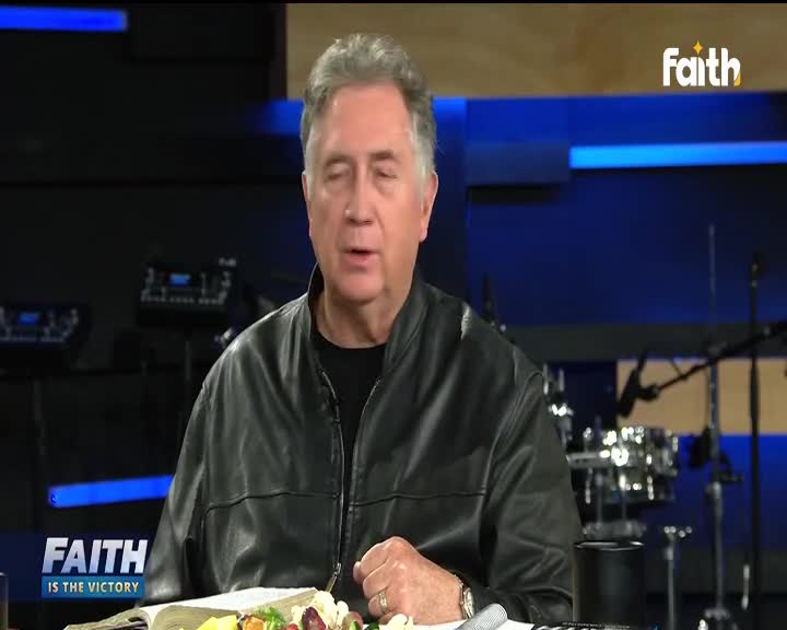 A man in a black leather jacket speaks directly to the camera, likely in a studio for Faith TV. A plate of food and an open book rest on the table in front of him.
