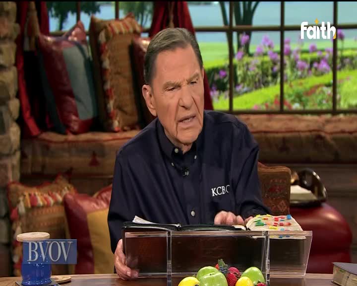 The man in the blue shirt gestures with his hands, speaking from behind a clear podium. A Faith TV logo sits in the corner, and a window with a garden view is behind him.
