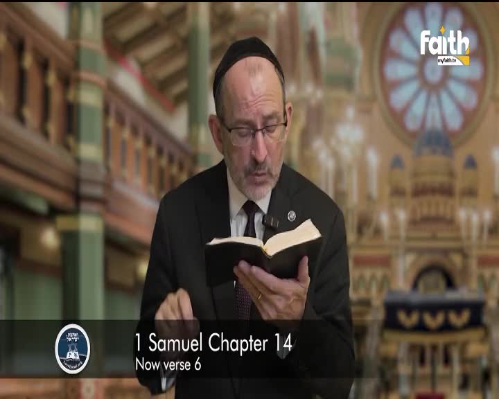 A man in a suit, wearing a kippah, reads from a small book, his lips moving as he speaks. The Faith TV logo is visible in the corner, and the backdrop is a blurred interior, likely a synagogue in South Africa.

