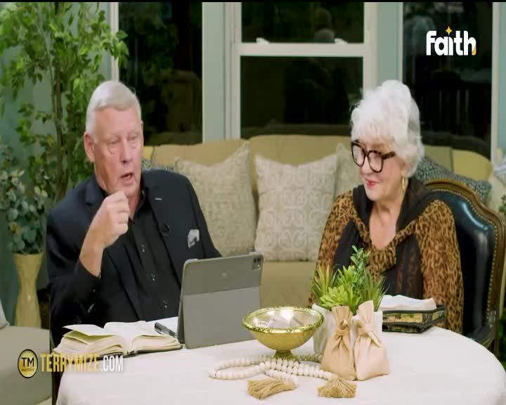 A man in a black suit speaks with his hand raised, while a woman in a leopard-print top smiles beside him. Their conversation is broadcast on Faith TV, a channel popular in South Africa.