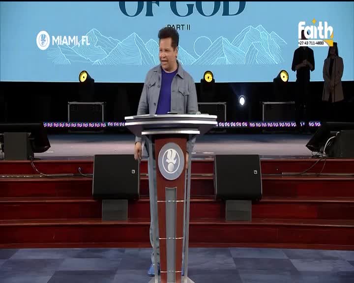 A man in a denim jacket stands behind a podium, speaking to an unseen audience. The Faith TV logo is visible, indicating the broadcast originates from South Africa. A man in a denim jacket stands behind a podium, speaking to an unseen audience. The Faith TV logo is visible, indicating the broadcast originates from South Africa.