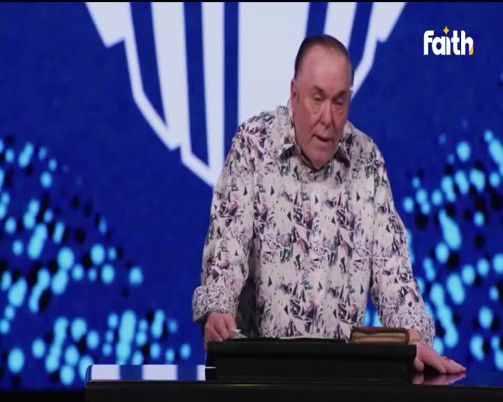 A man in a patterned shirt leans over a lectern, his hand resting on a thick book. The Faith TV logo is visible on the blue backdrop behind him.