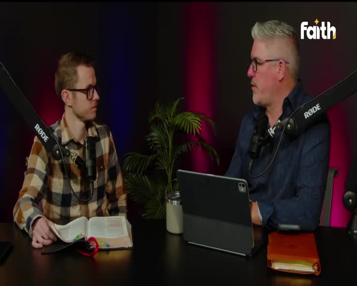Two men are seated at a table, microphones positioned in front of them. One man, wearing glasses and a plaid shirt, turns a page in an open Bible. The Faith TV logo is visible in the background.