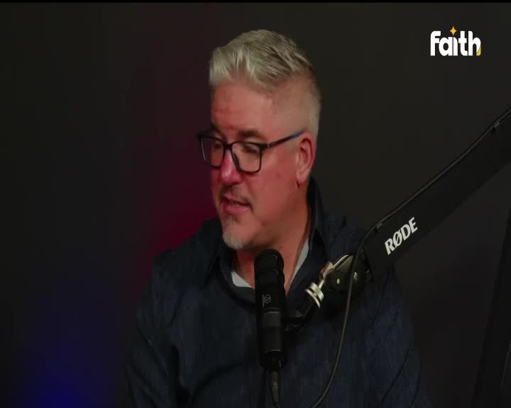 The man with grey hair and glasses leans into the microphone, speaking into it. The Faith TV logo sits in the corner, a subtle reminder of the broadcast.