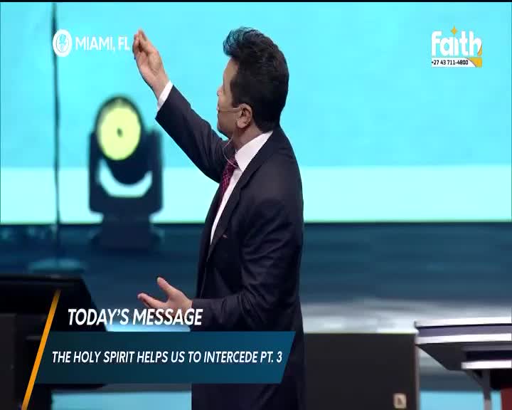 The speaker gestures upwards, his right hand raised. Below him, a screen displays "TODAY'S MESSAGE" and "THE HOLY SPIRIT HELPS US TO INTERCEDE PT. 3."