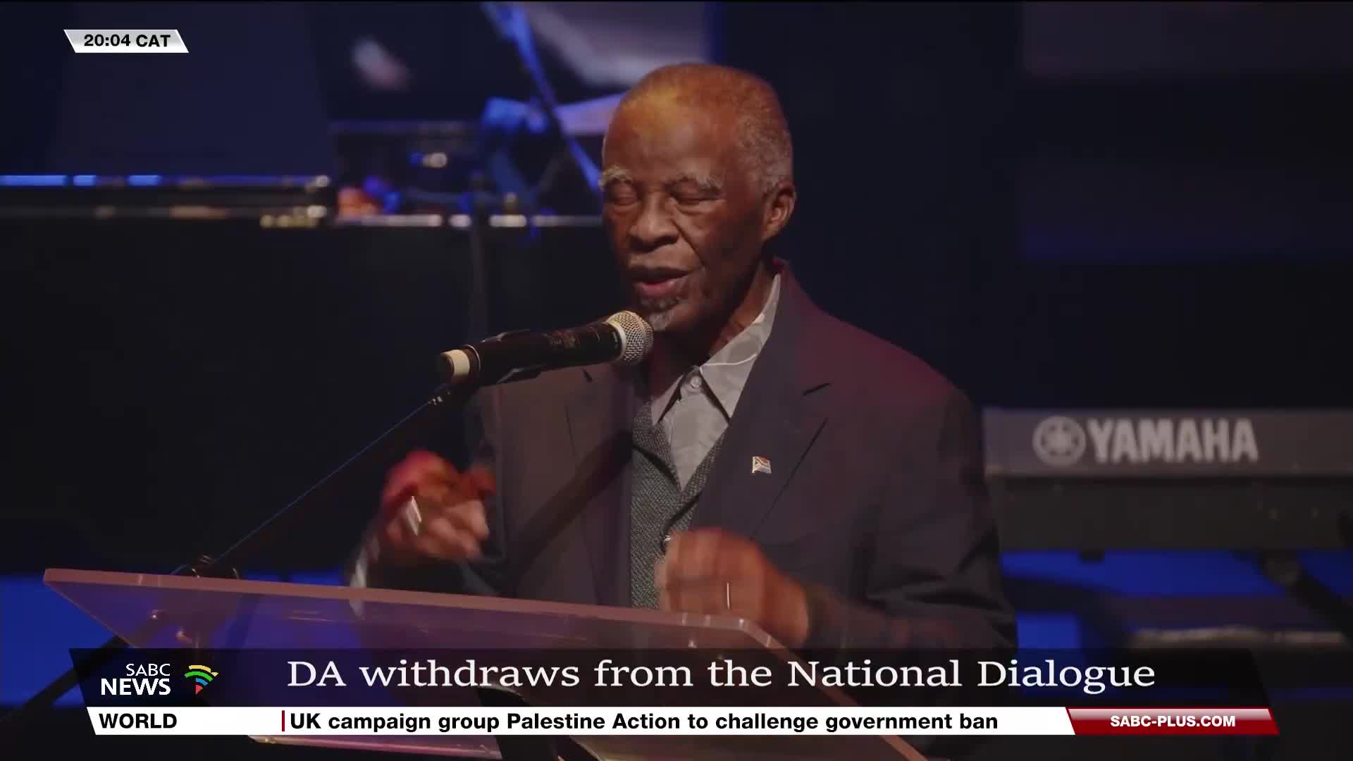 A man in a dark suit speaks into a microphone, his hands gesturing as he addresses the audience. The SABC News logo is visible, and the headline states that the DA is withdrawing from the National Dialogue.
