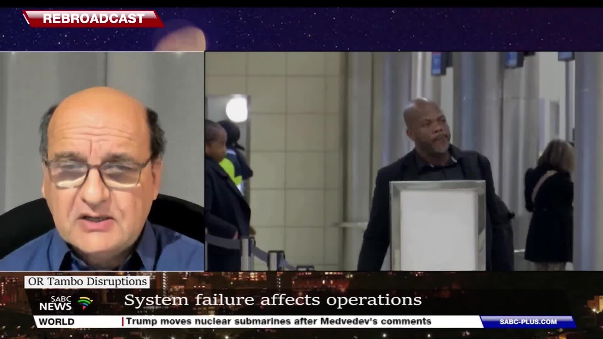 On the left, a man in glasses speaks, while on the right, a man in a dark jacket stands at what appears to be an airport security checkpoint. People walk behind him, and the SABC News banner at the bottom indicates this is coverage of disruptions at OR Tambo International Airport.
