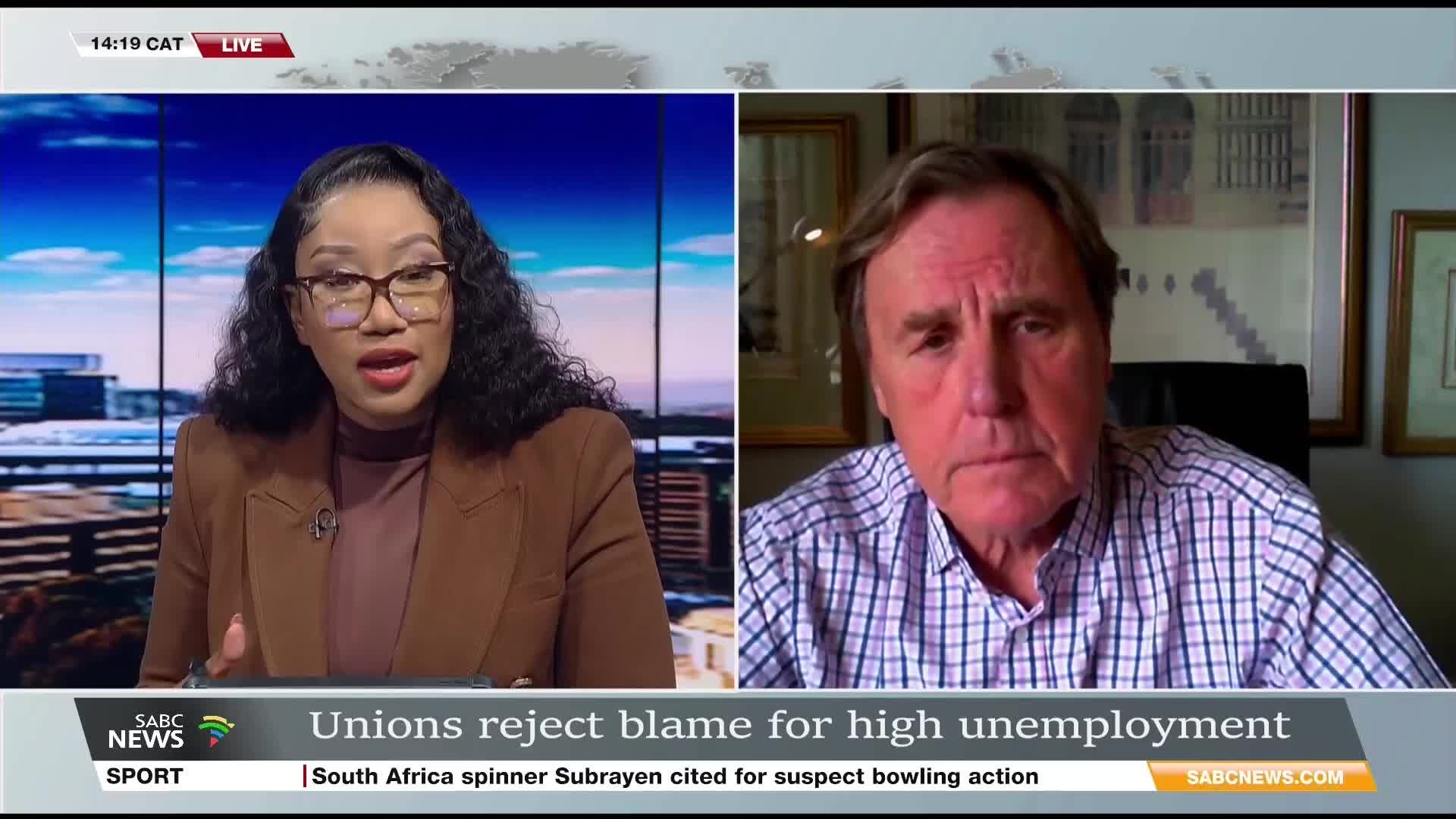 On SABC News, a presenter in a brown jacket speaks passionately, while a man on the right, framed in a smaller window, listens intently. The chyron beneath them discusses unemployment in South Africa.
