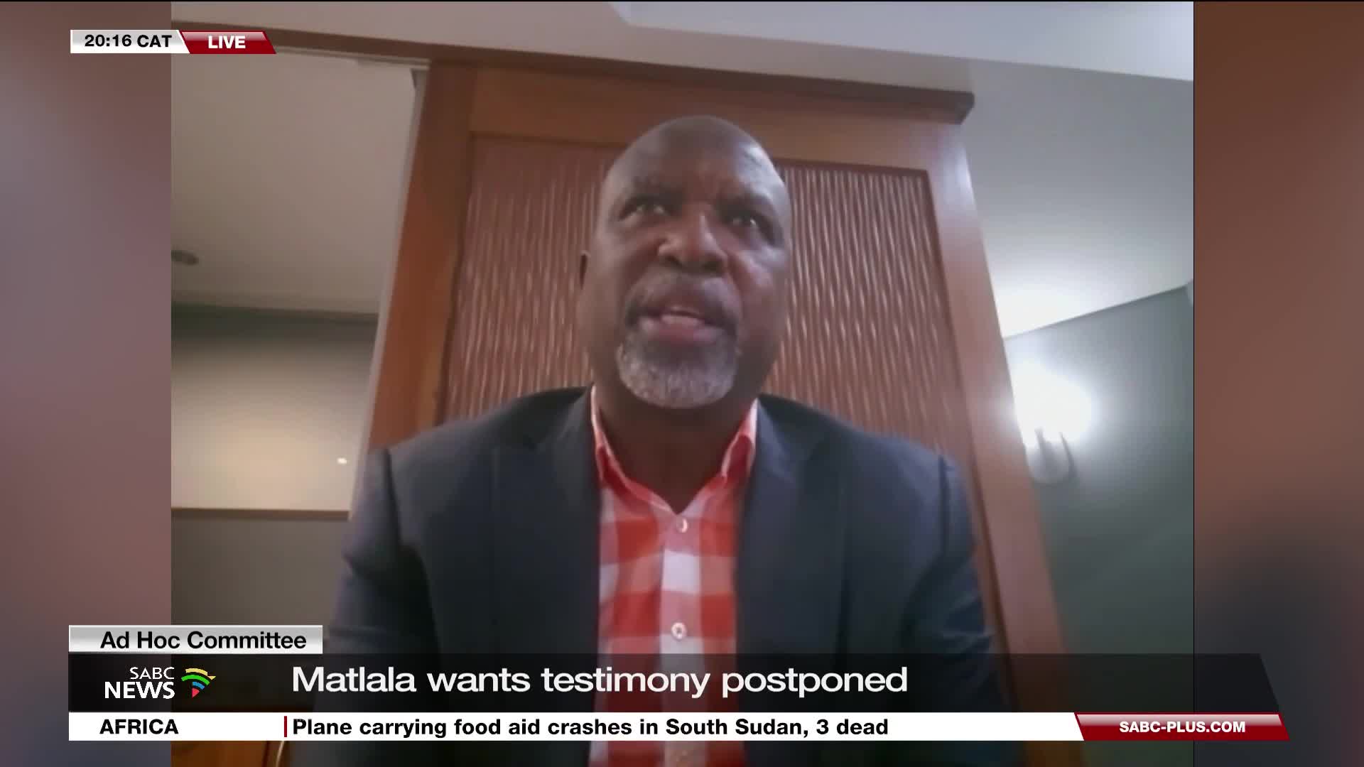 A man in a blazer and checkered shirt speaks directly to the camera, his mouth moving as he addresses the SABC News audience. The lower third of the screen displays headlines about a postponed testimony and a plane crash in South Sudan.
A man in a blazer and checkered shirt speaks directly to the camera, his mouth moving as he addresses the SABC News audience. The lower third of the screen displays headlines about a postponed testimony and a plane crash in South Sudan.