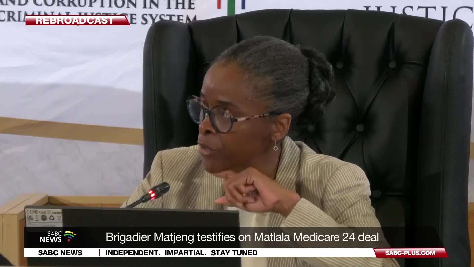 Brigadier Matjeng is testifying, her hands clasped as she speaks. The SABC News chyron below identifies her testimony concerning the Matlala Medicare 24 deal.