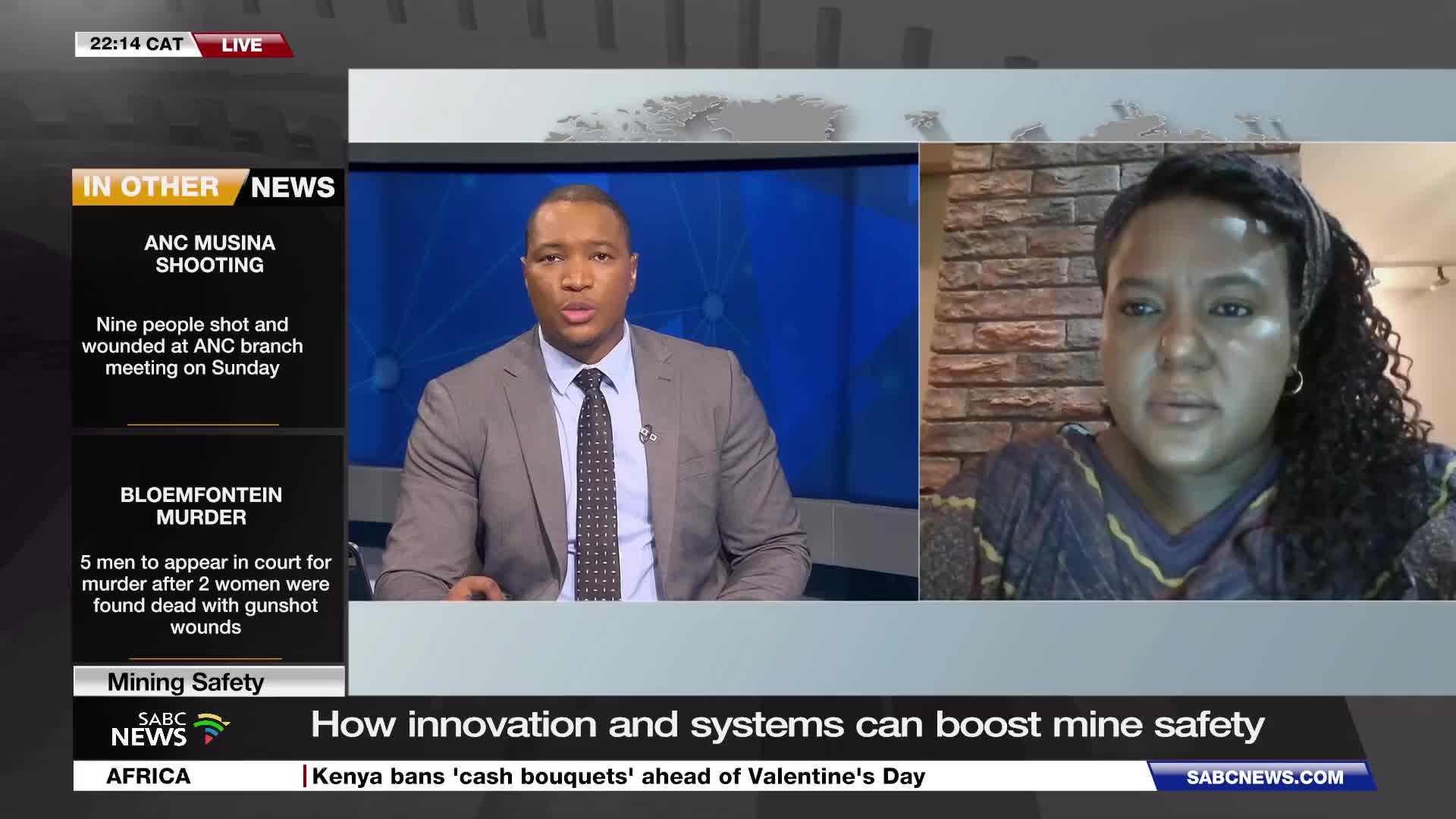 A news anchor in a suit sits at a desk, speaking to a woman on a screen. The SABC News banner scrolls across the bottom of the screen.