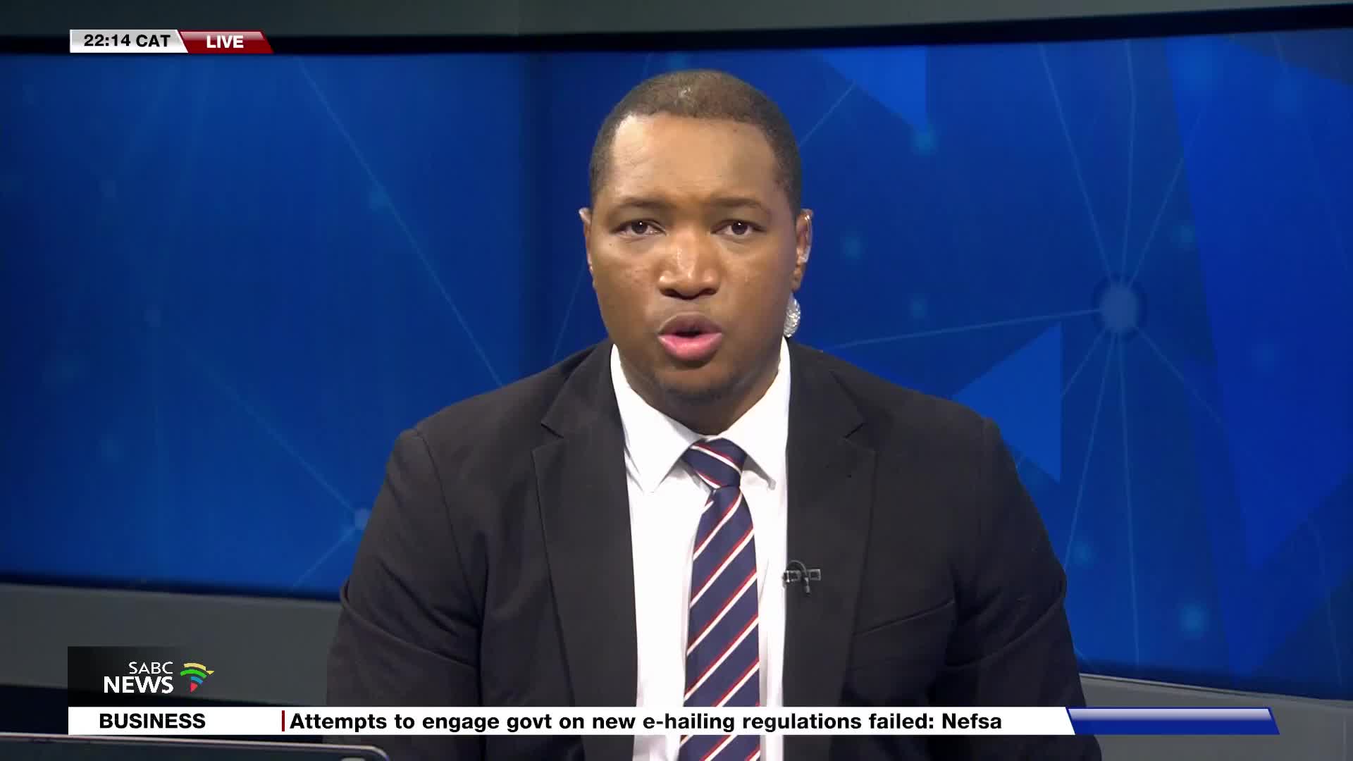 A man in a suit and tie is speaking directly into the camera. The SABC News graphic appears at the bottom left of the screen.