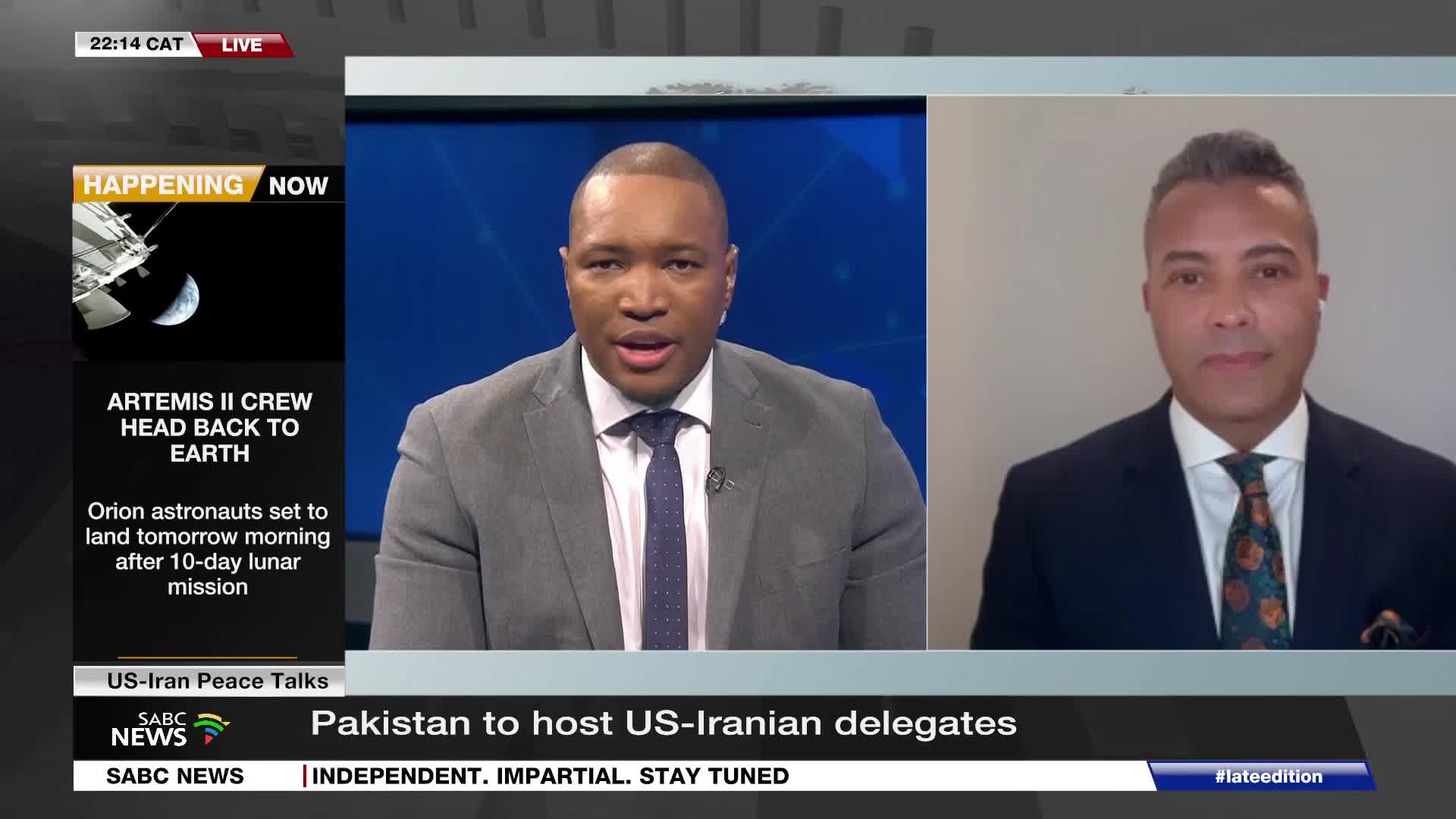 A SABC News anchor is speaking, with a split screen showing a man in a suit. The screen also displays a breaking news graphic about Artemis II and a headline about US-Iran peace talks.