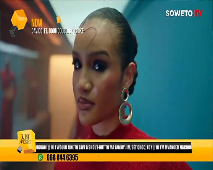 On Soweto TV, a woman with dark, dramatic eye makeup looks directly at the camera, her large hoop earrings catching the light. A promo for Davido featuring Odumodublvck and Chike plays on the screen.
