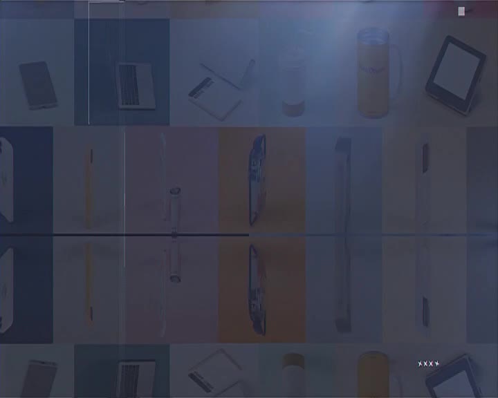 A grid of objects, including a laptop, phone, and mug, is arranged against a backdrop of colored squares. The image is slightly distorted, as if it's being broadcast on Soweto TV.
