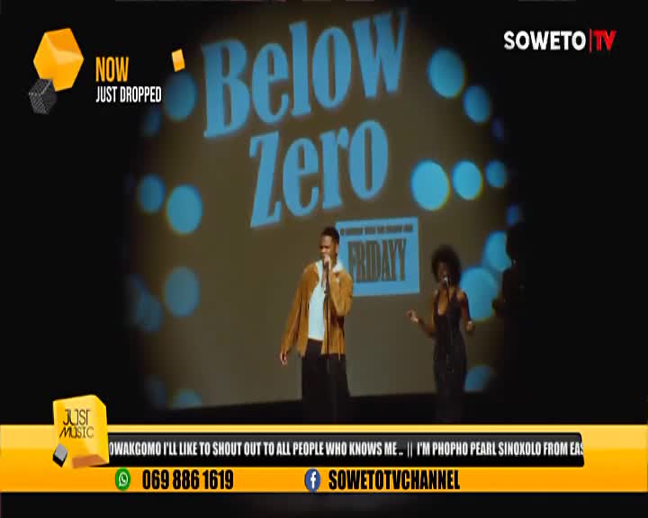 On the Soweto TV stage, a man in a brown jacket and a woman in a black dress are singing, their voices amplified by microphones. The backdrop reads "Below Zero" in large letters, and the Just Music logo is displayed in the corner.
