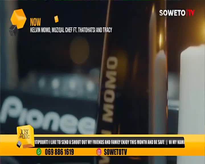 A music video is playing on Soweto TV, with the names of Kelvin Momo, MuziQal Chef, Thatohatsi, and Tracy displayed. The camera focuses on a Pioneer DJ mixer and a candle, while a yellow banner scrolls across the bottom.

