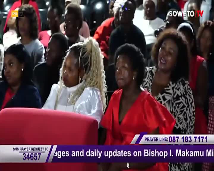 A woman in a bright red dress sings with her eyes closed, her head tilted back. Beside her, a woman with blonde braids looks forward, her expression thoughtful. The Soweto TV logo is visible in the background. A woman in a bright red dress sings with her eyes closed, her head tilted back. Beside her, a woman with blonde braids looks forward, her expression thoughtful. The Soweto TV logo is visible in the background.