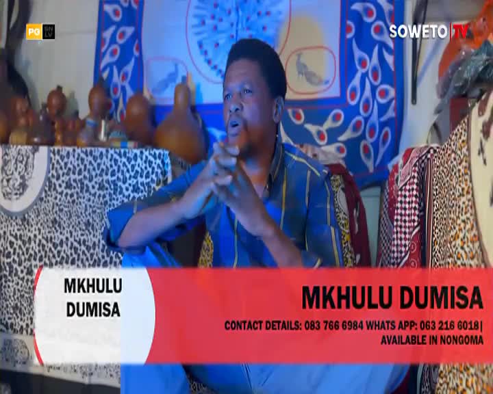 Mkhulu Dumisa speaks, his hands clasped, in front of colourful South African textiles. A Soweto TV graphic identifies him and lists contact details.