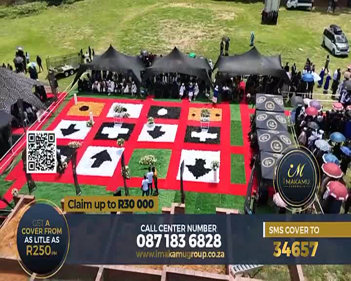 A procession of mourners in black and white moves under black tents, their path marked by a vibrant red carpet and intricate floral arrangements. The Soweto TV logo and funeral service advertisements overlay the scene, a stark contrast to the solemn occasion.