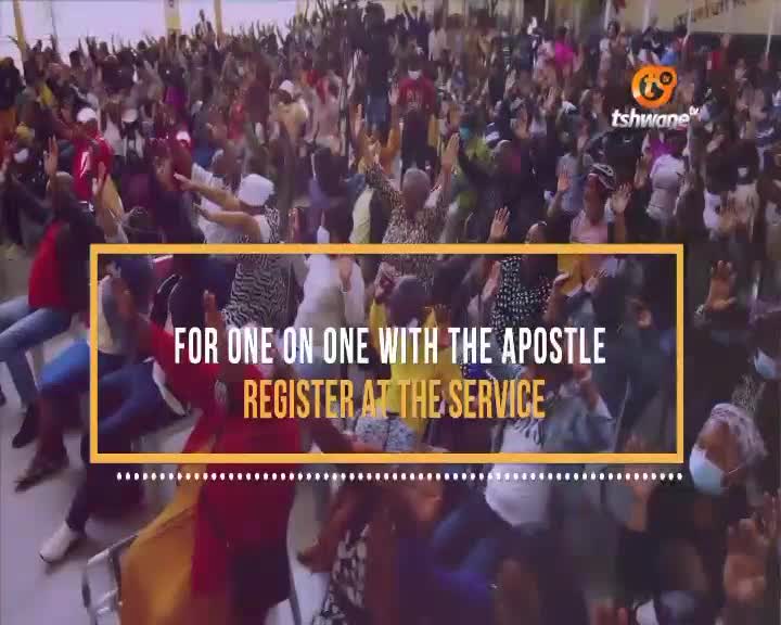 People are packed together, many with their arms raised, seemingly in prayer or praise. A Tshwane TV graphic promotes one-on-one meetings with the Apostle, inviting registration at the service.
