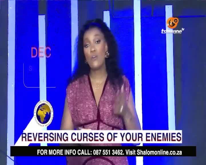 A woman in a pink dress gestures as she speaks on Tshwane TV. The screen displays a message about reversing curses, with a call to action at the bottom.
