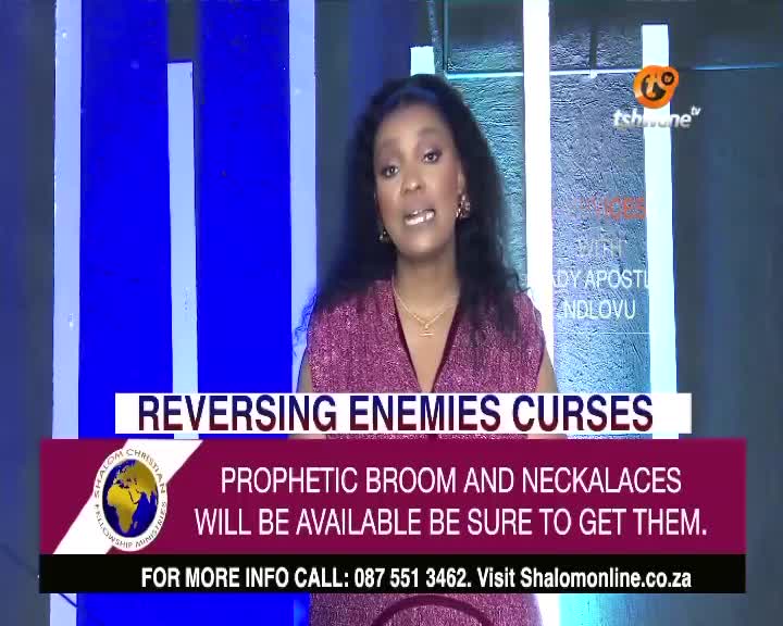 On Tshwane TV, a woman with dark hair is speaking, her mouth moving as she gestures with her hands. A lower third graphic proclaims "Reversing Enemies Curses" and advertises prophetic items from Shalom Christian Fellowship Ministries.
