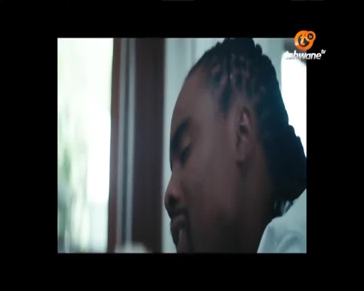 A man with braided hair is looking down, his face in profile. The Tshwane TV logo appears in the top right corner.