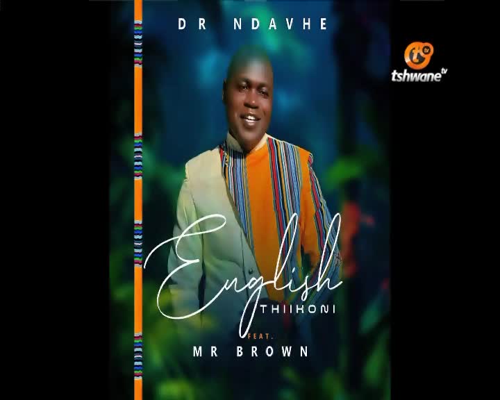 A man in a vibrant, striped garment smiles broadly, standing against a backdrop of lush greenery. Text overlays the image, announcing "English THIIHONI" featuring "MR BROWN," with the Tshwane TV logo visible. A man in a vibrant, striped garment smiles broadly, standing against a backdrop of lush greenery. Text overlays the image, announcing "English THIIHONI" featuring "MR BROWN," with the Tshwane TV logo visible.