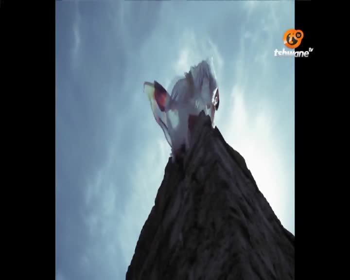 A white and red parachute billows against the Tshwane sky. It's attached to a rough, dark surface that stretches upwards.