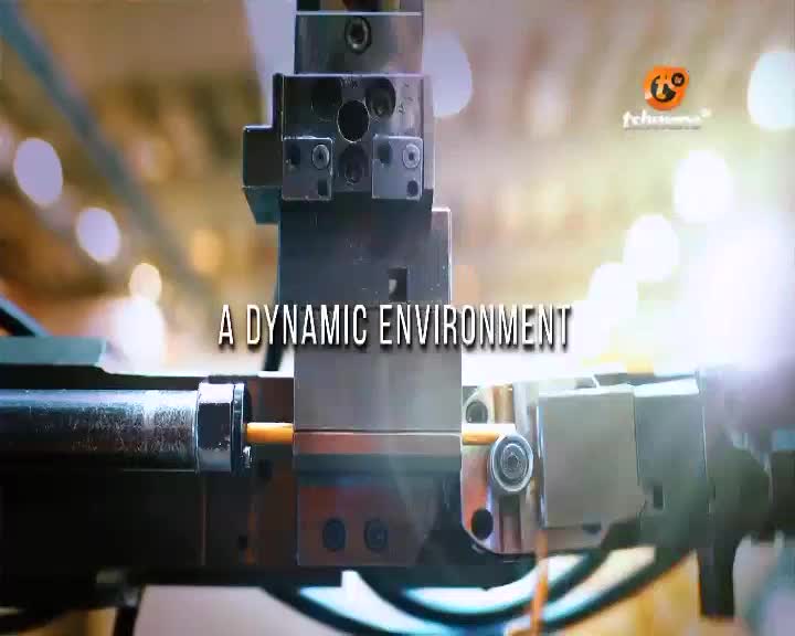 A metal rod is being fed into a complex machine. The Tshwane TV logo is visible in the background. A metal rod is being fed into a complex machine. The Tshwane TV logo is visible in the background.