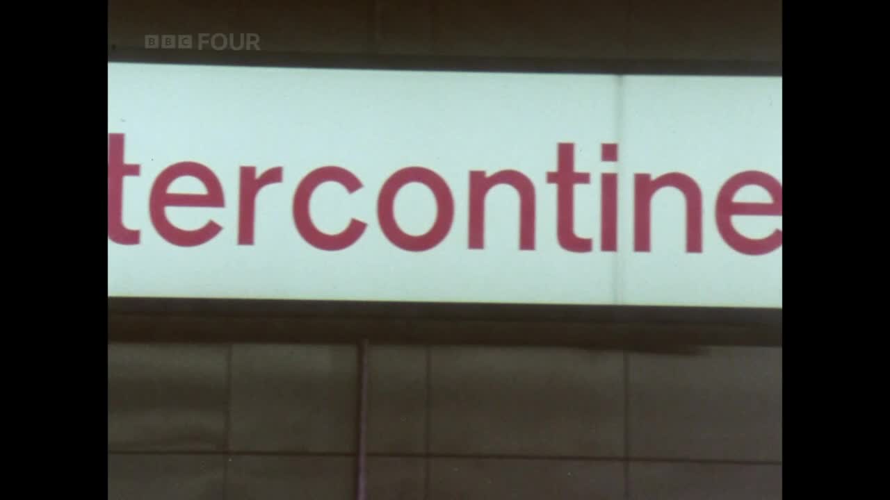 The word "intercontine" in red letters is lit up on a sign, with "BBC FOUR" in the corner. The sign is mounted on a tiled wall.

