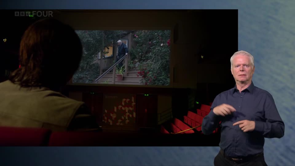 An older gentleman in a dark suit walks down wooden steps. The BBC Four logo appears in the top left corner of the screen.