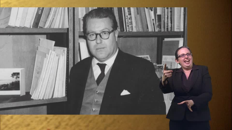 A black and white photograph of a man in a suit stands beside a woman in a suit, who is signing with animated gestures. This appears to be part of a BBC Four broadcast from the UK.