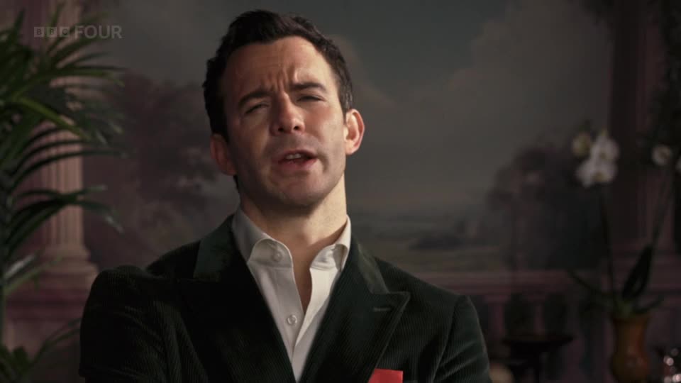 The man in the green jacket leans forward, speaking intently. A BBC Four logo is visible in the top left corner.