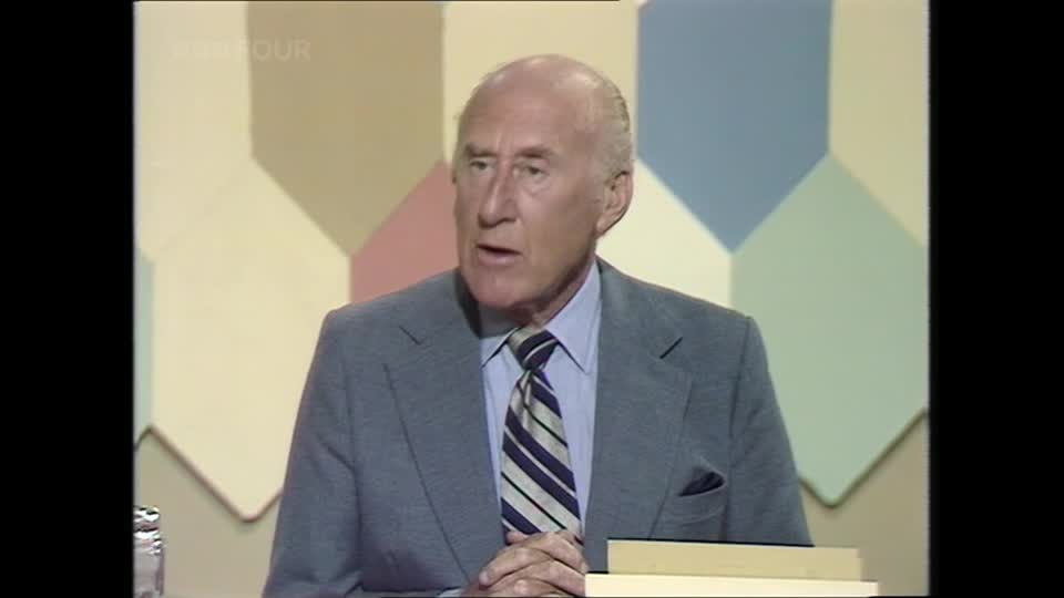 A man in a grey suit and striped tie speaks animatedly. The BBC Four logo is visible in the top left corner.
