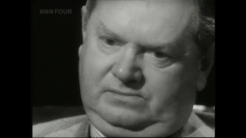 A man's face fills the screen, his brow furrowed and his gaze intense. BBC Four's logo appears in the top left corner.