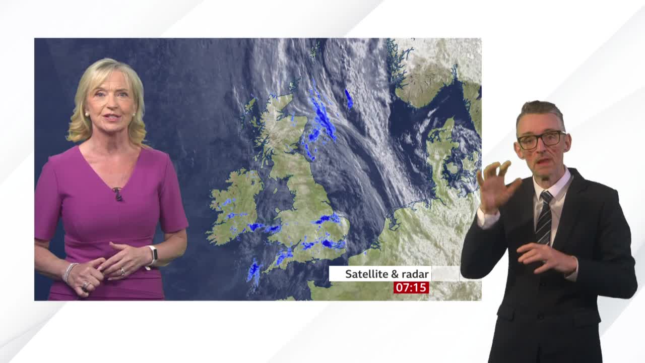 A BBC News weather report is underway, with a woman in a pink dress speaking, while a man in a suit uses hand gestures. The screen behind them shows a satellite image of the United Kingdom, highlighting weather patterns.
