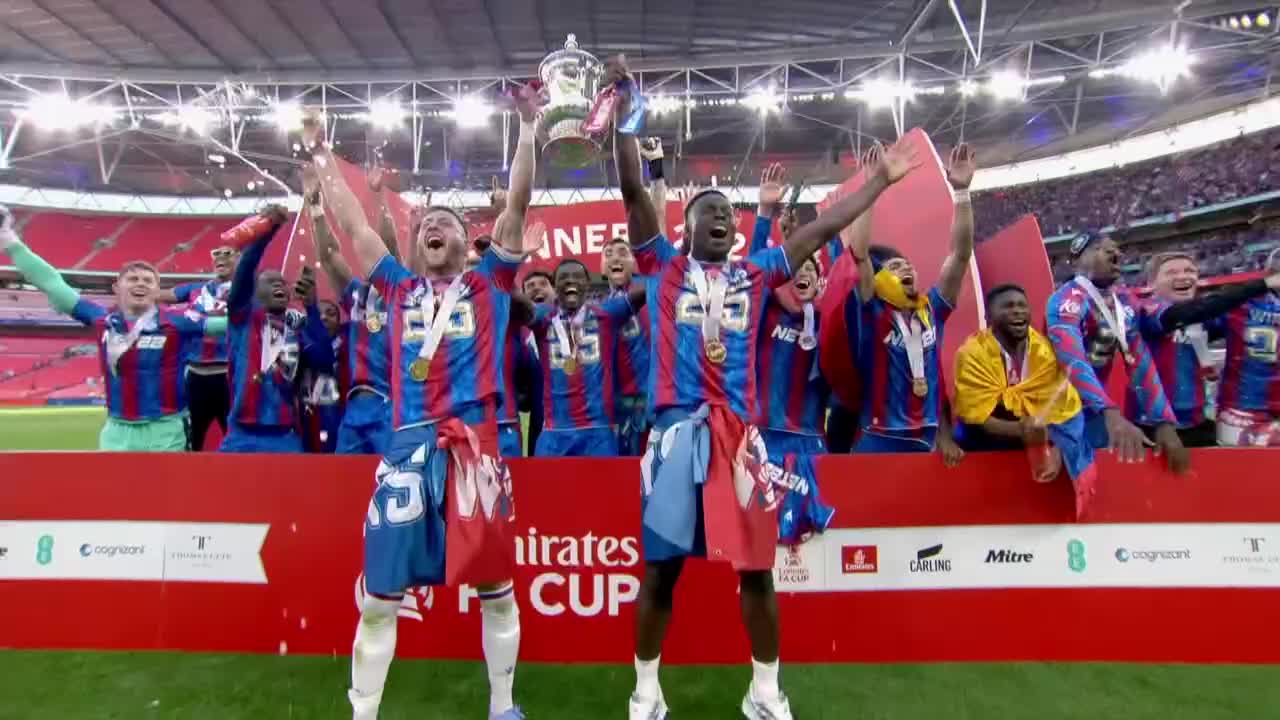 Players in matching blue and red jerseys hoist the trophy high above their heads, confetti raining down around them.  They're celebrating a victory, their faces lit up with joy at Wembley Stadium, as reported by BBC News in the United Kingdom.
