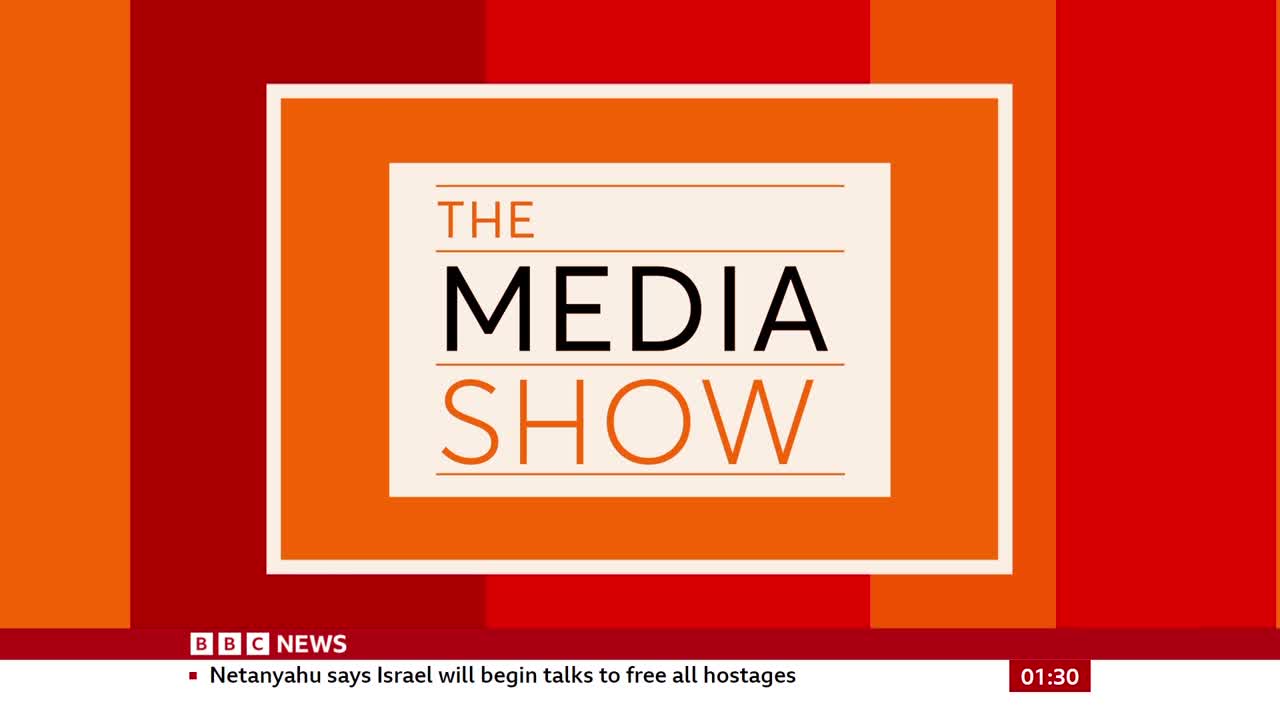 The BBC News program "The Media Show" is displayed on screen, its title centered within a geometric orange and red background. Breaking news about Israel and hostage talks scrolls at the bottom.
