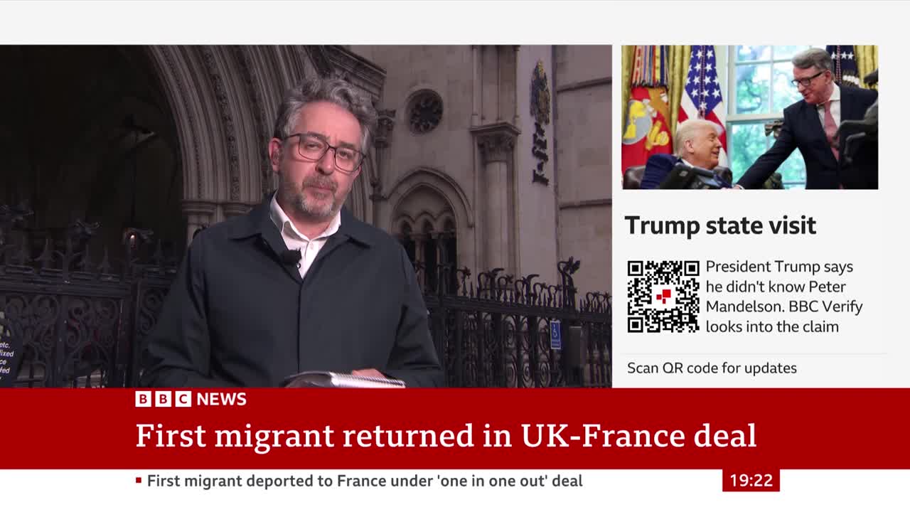 A BBC News presenter, standing outside a building, addresses the camera with a serious expression. The screen displays the headline "First migrant returned in UK-France deal," with a smaller segment about a Trump state visit.
