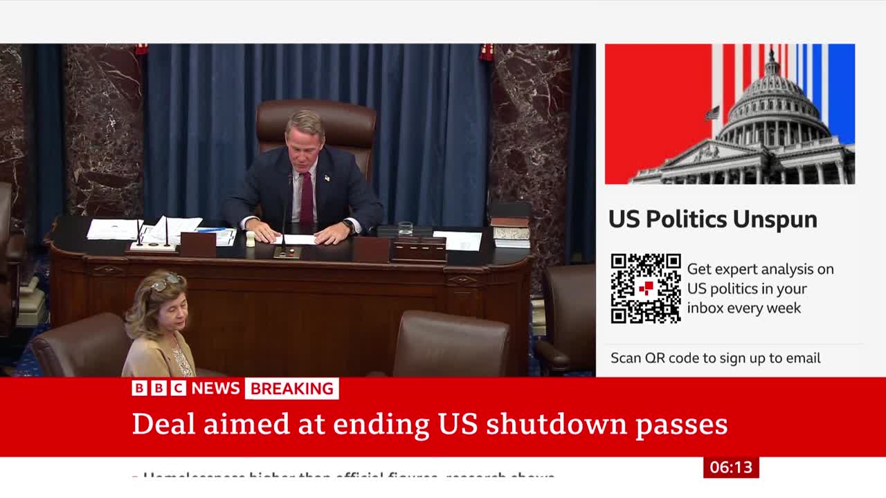 A man in a suit, seated at a desk, is looking down at papers. The BBC News banner at the bottom reports a deal has passed, aiming to end the US shutdown.
A man in a suit, seated at a desk, is looking down at papers. The BBC News banner at the bottom reports a deal has passed, aiming to end the US shutdown.