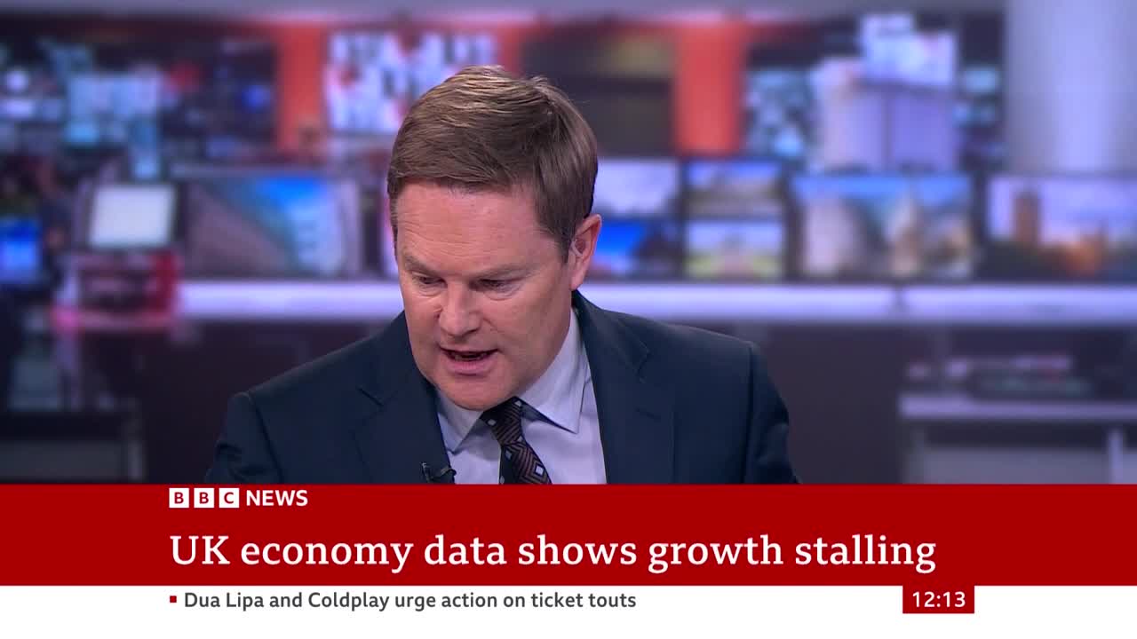 A man in a dark suit speaks directly to the camera, his mouth open as he delivers the news. Below him, a BBC News banner announces a slowdown in the UK economy.
A man in a dark suit speaks directly to the camera, his mouth open as he delivers the news. Below him, a BBC News banner announces a slowdown in the UK economy.