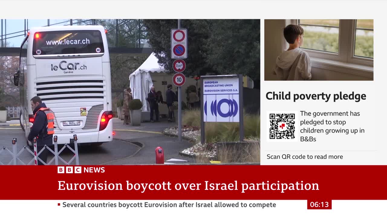 A large white bus with "leCar.ch" on the back is parked near a tent. A man in an orange vest stands next to a barrier, and the BBC News graphic at the bottom reports on a Eurovision boycott.
