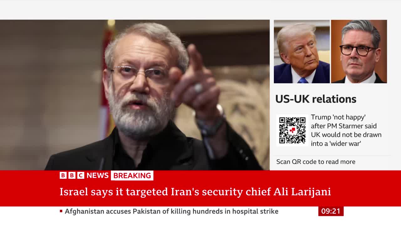 A man with glasses and a beard gestures with his right hand while speaking. Beside him, a BBC News graphic displays headlines about US-UK relations and an Israeli strike on Iran's security chief.
